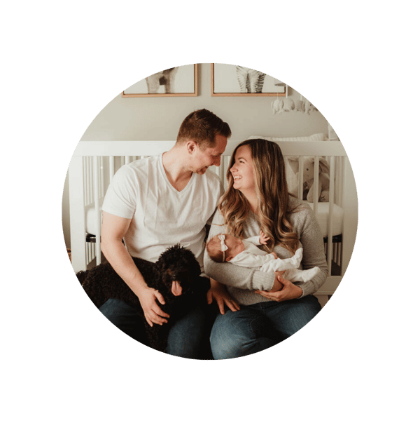 new parents with baby girl in nursery