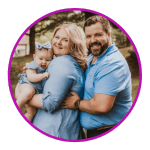 husband and wife holding baby girl wearing blue