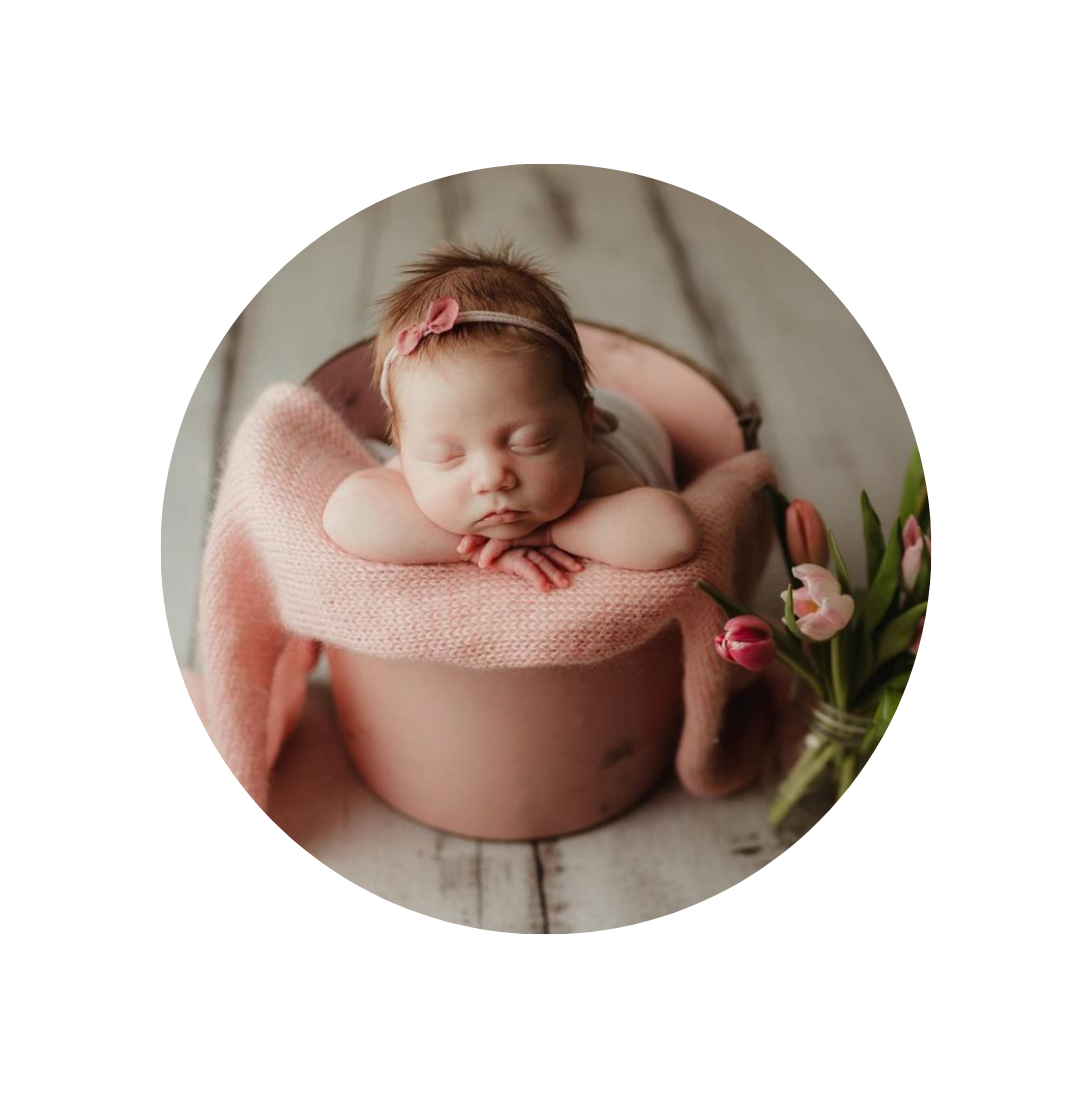 baby girl in pink flower pot sleeping