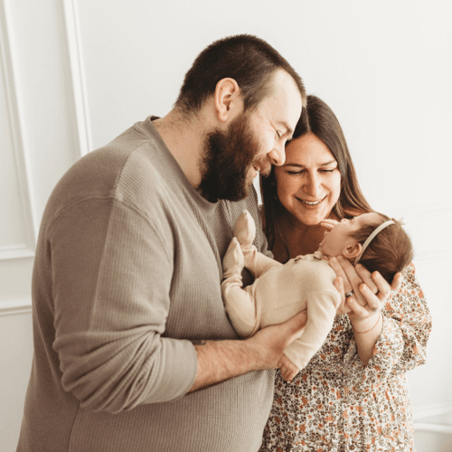 Happy parents holding their newborn daughter