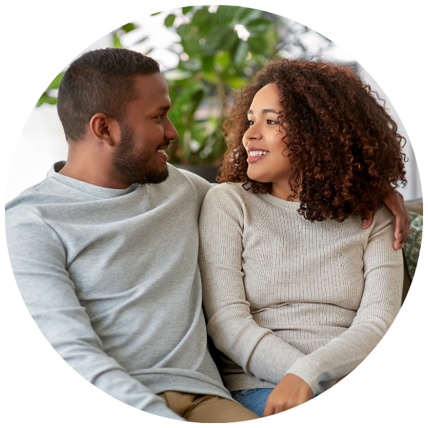 couple looking at each other smiling discussing finances and fertility planning