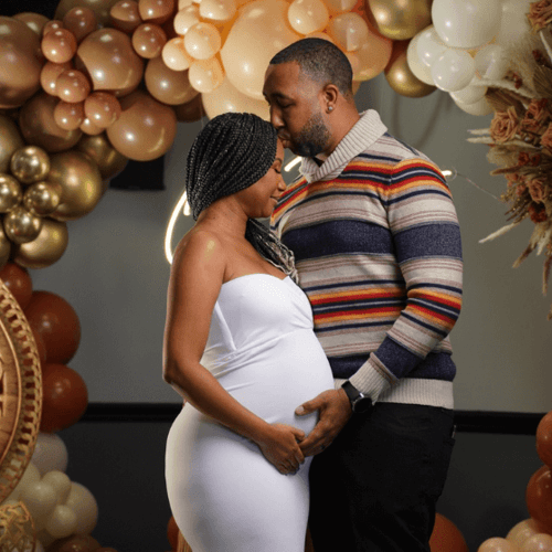 A couple embraces at their baby shower