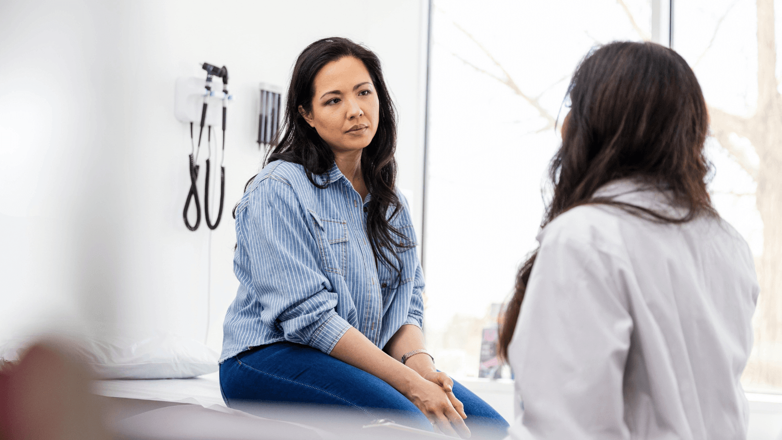 Female patient consulting with doctor