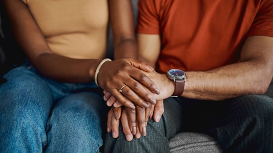 couple-sitting-holding-hands