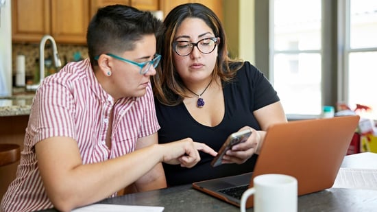 an lgbtq+ couple discussing fertility treatment costs together