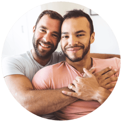 gay couple embracing on sofa