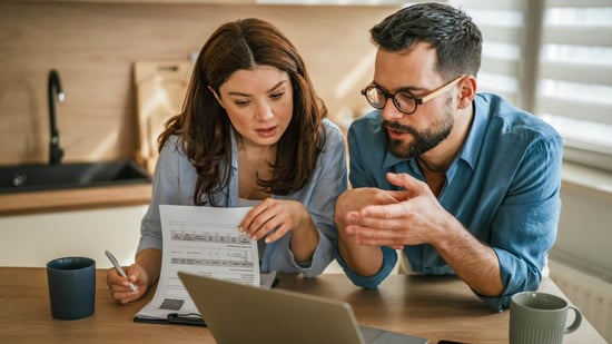 Couple reviewing fertility treatment expenses and insurance coverage while researching IVF costs in Connecticut
