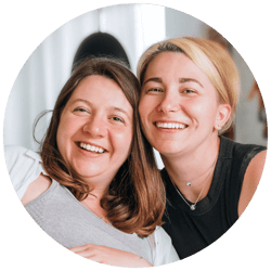 lesbian couple smiling at home