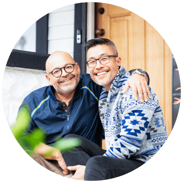 lgbtq-two-dads-couple-smiling-front-steps