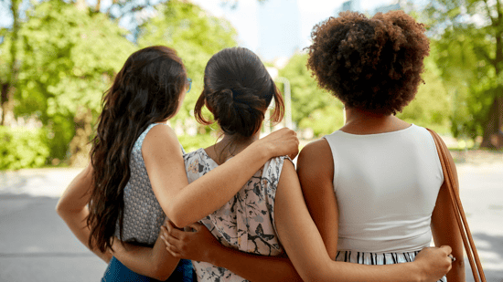 three-women-standing-together-looking-away