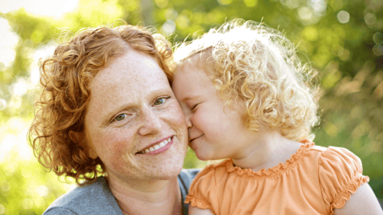 smiling-mother-with-child-outside