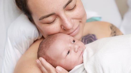 a new mother holds her newborn baby in the hospital